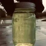 Mystery Jar Filled with Yellow Liquid Outdoors