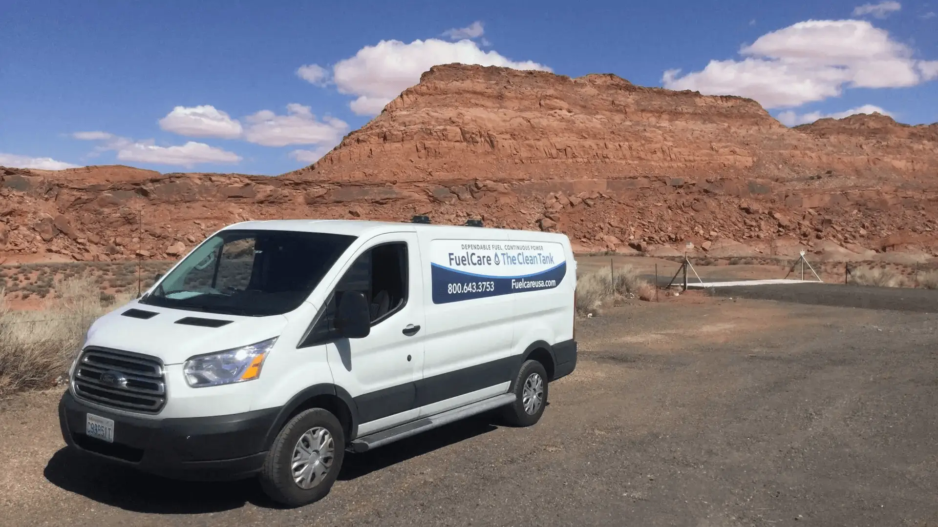 White service van near red rock formations under blue sky for FuelCare & The Clean Tank.